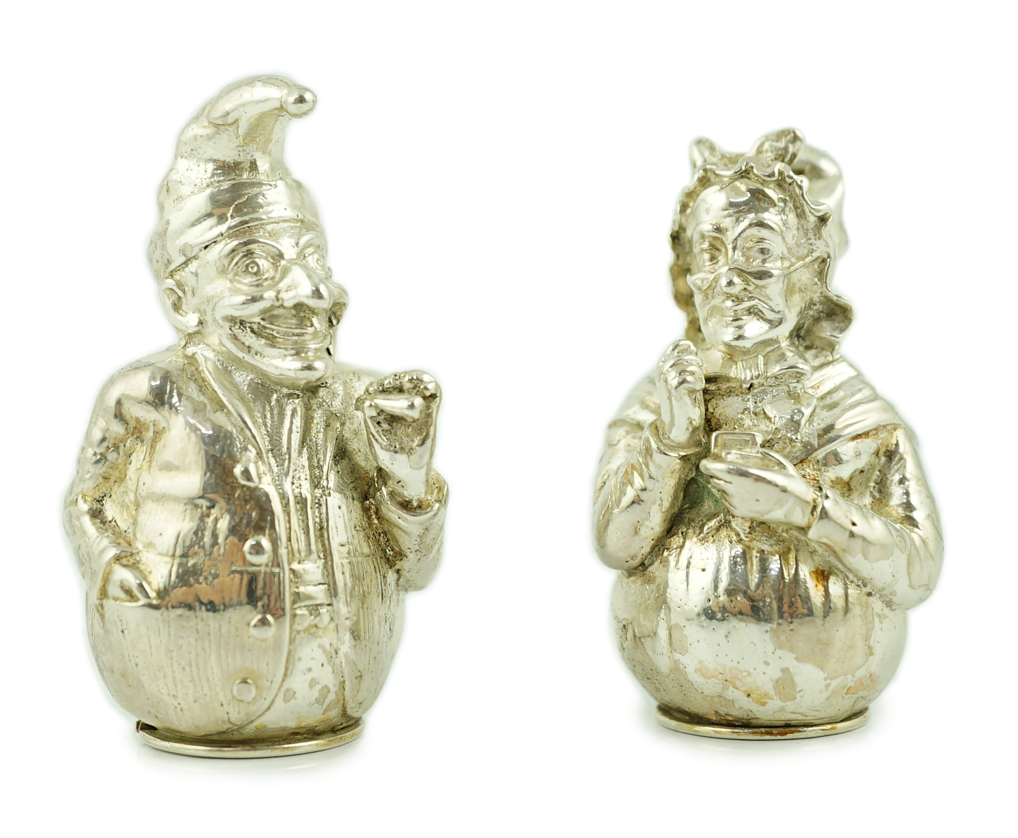 A pair of cast late Victorian novelty silver pepperettes, modelled as Punch and Judy, Edward H. Stockwell